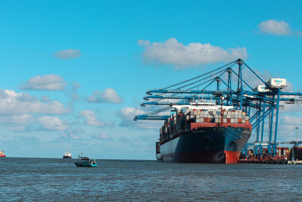 Container ship berthed under gantry cranes at a seaport terminal